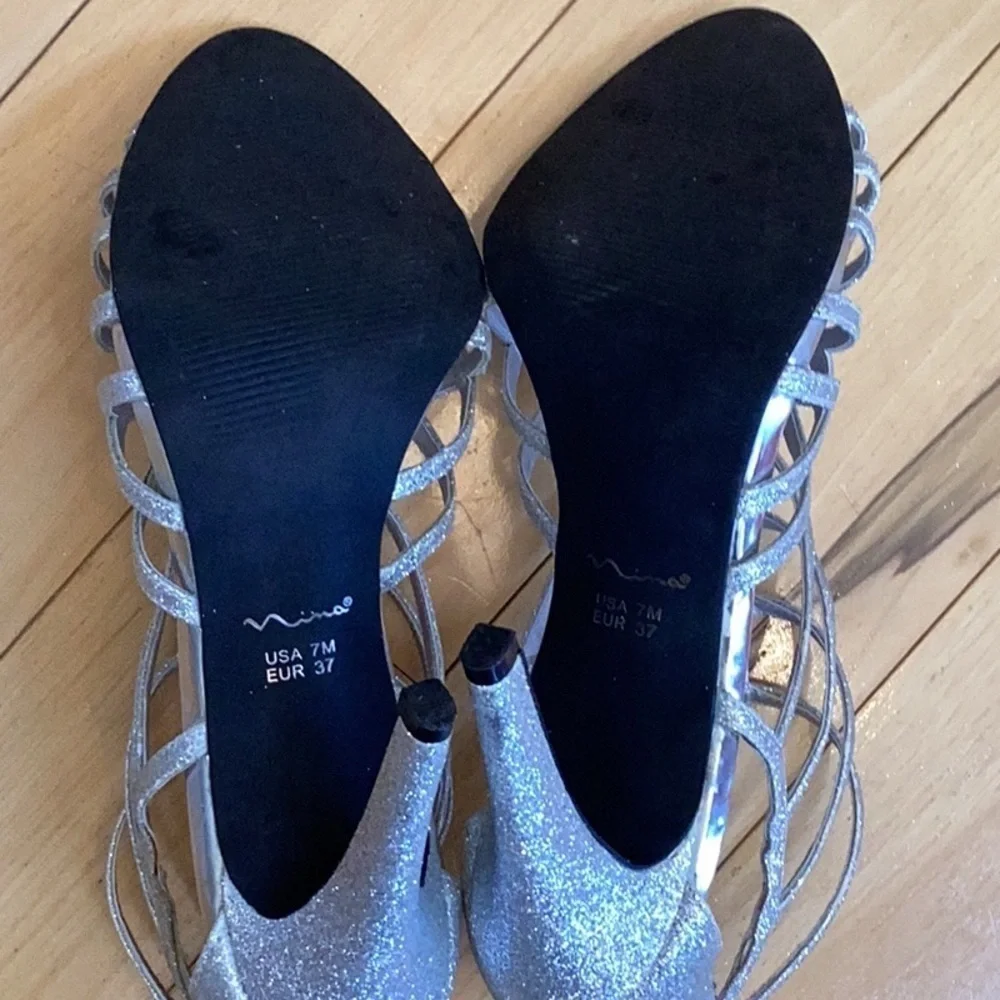 Nina silver glittery, strappy high heels, zipper to back. Women’s size 7